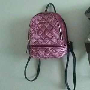A pink Aldo backpack purse